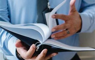 A Man Looking Through a Binder